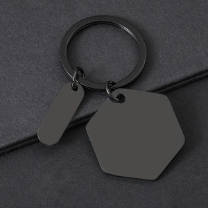Macro detail of matte black stainless steel hexagon and oval blank metal keychains