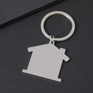 Macro shot of house shaped stainless steel keychain with polished silver metal finish