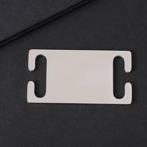 Polished stainless steel pet tag with side openings for collars shown on dark texture