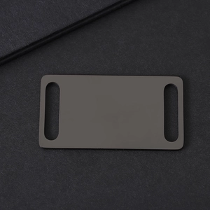 Detailed macro view of a matte black curved metal plate for custom pet collar engraving