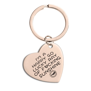 Close-up of rose gold heart keychain with engraved inspirational quote and sun icon
