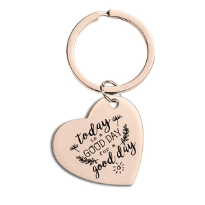 Close-up of heart keychain with motivational engraving in rose gold finish