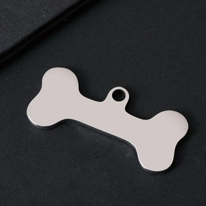 Detailed view of bone-shaped stainless steel pet ID tag with polished silver finish