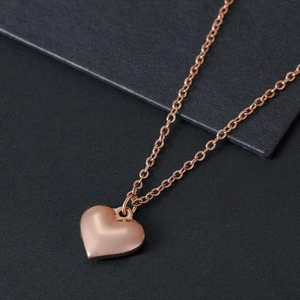 Polished rose gold heart pendant necklace with minimalist O-chain on black display