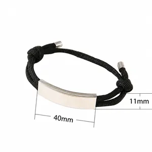 Adjustable black woven rope bracelet with curved silver metal plate in minimalist design