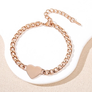 Elegant rose gold stainless steel Cuban chain bracelet with a polished heart charm
