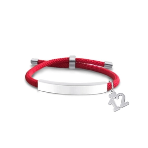 Detail of red braided bracelet featuring silver metal plate and crown number 12 pendant