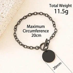 Detail of black stainless steel OT toggle bracelet with a 20mm round blank tag pendant