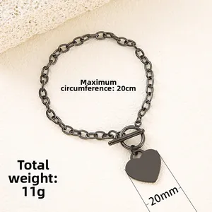 Gunmetal stainless steel chain bracelet with heart charm and T-bar clasp detail