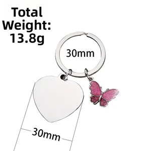 Detail of stainless steel keyring with pink glitter butterfly and heart-shaped pendant