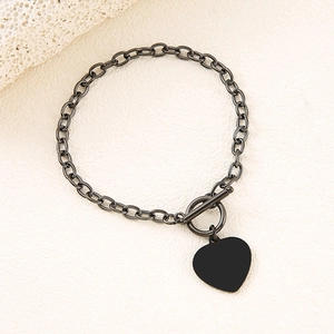 Detail view of heart charm bracelet with T-bar toggle closure in gunmetal black finish