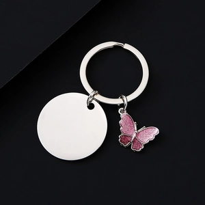 Detail of butterfly keychain with pink glitter pendant and polished blank metal tag