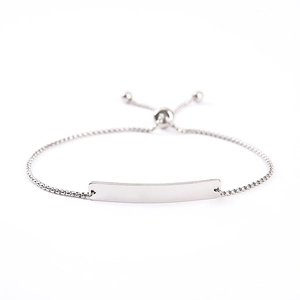 Close-up of silver adjustable bolo bracelet with blank curved stainless steel ID plate