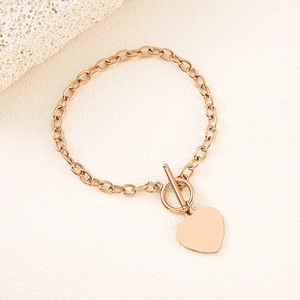 Close-up of rose gold heart pendant bracelet with a classic toggle clasp design