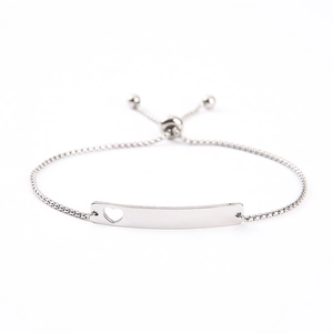 Detail view of adjustable stainless steel bracelet with cutout heart bar and slider clasp
