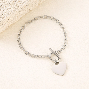Close-up of a silver heart pendant bracelet with a stylish OT toggle clasp and chunky chain