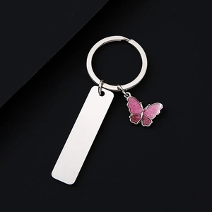 Polished stainless steel keychain with pink glittery butterfly charm and metal tag
