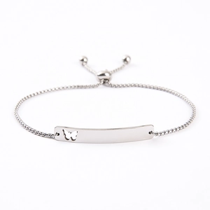 Detail of silver adjustable bracelet with hollow butterfly bar and polished finish