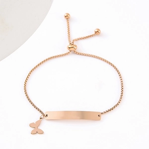 Detail of rose gold adjustable box chain bracelet with engraved bar and butterfly charm