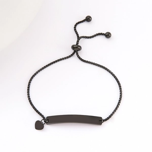 Detail of adjustable black stainless steel bracelet with curved bar and heart pendant