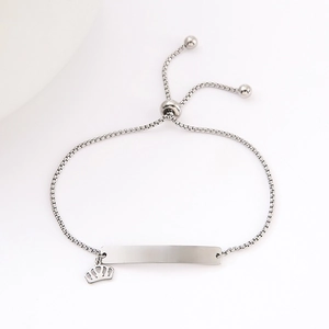 Detail of adjustable box chain bracelet with rectangular bar and hollow crown charm
