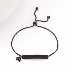 Detail of black stainless steel ID bar bracelet with crown charm and slider clasp