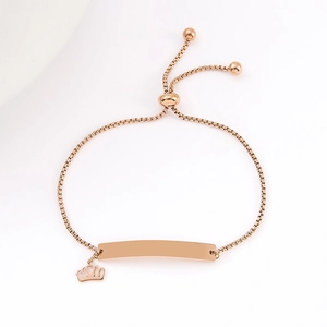 Detail of rose gold bar bracelet with crown charm and adjustable sliding bead clasp