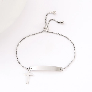 Macro view of adjustable stainless steel box chain with curved plate and cross charm