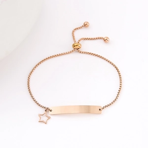 Detail of rose gold adjustable box chain bracelet with bar plate and star charm