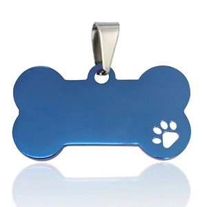 Detail view of bone-shaped blue stainless steel pet ID tag with a hollow paw print design