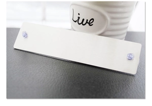 Detail of rectangular brushed stainless steel car parking card with dual suction cups