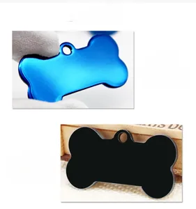 Detail of bone-shaped metal pet ID tags in blue and black matte aluminum finish