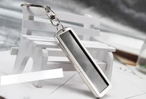 Detail of a minimalist rectangle metal keychain with silver frame and grey brushed metal insert