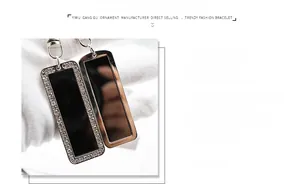 Detail of polished stainless steel rectangle pendants with rhinestone inlay craftsmanship