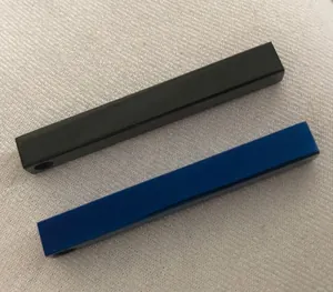 Macro shot of minimalist long rectangular cube pendants in matte black and blue finish