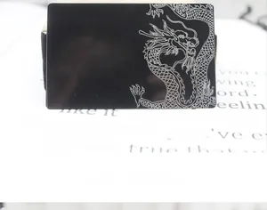 Detailed laser engraved dragon pattern on a black 0.2mm metal business card