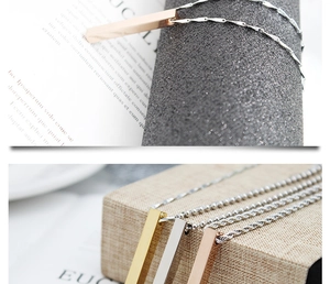 Macro view of minimalist polished stainless steel bar pendants in gold and silver finish