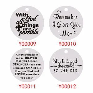 Detail of four stainless steel keychains with engraved motivational English quotes