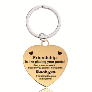 Detail of gold heart keychain with funny friendship quote and polished metal finish