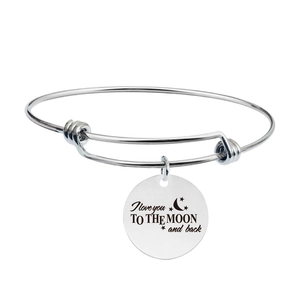 Detailed view of the silver stainless steel bracelet with engraved round message charm