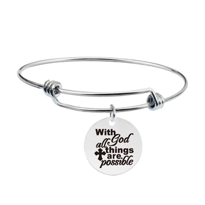 Detailed close-up of engraved inspirational message and cross on silver wire bracelet
