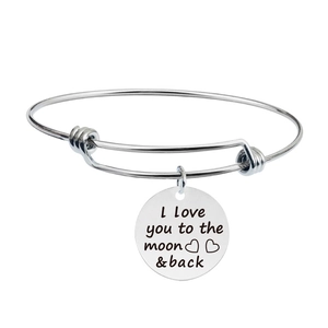 Polished silver cuff bracelet with engraved moon and back quote pendant detail
