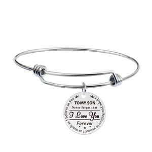 Detail shot of silver adjustable stainless steel bracelet with engraved gift pendant