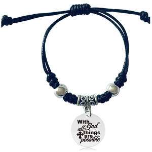 Detail of woven bracelet with engraved silver pendant featuring inspirational quote
