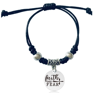 Detail view of woven rope bracelet featuring a polished disc engraved with faith OVER FEAR