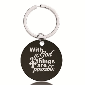 Detailed view of black round stainless steel keychain with engraved cross and bible verse