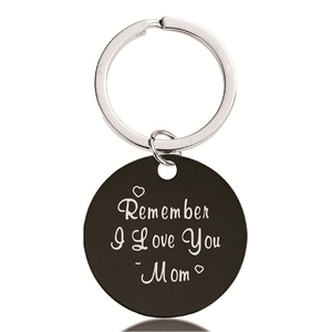 Detail of black round pendant engraved with Remember I Love You Mom text for keychain