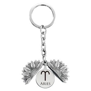 Macro detail of Aries zodiac sunflower keychain showing the flip-open silver metal petal