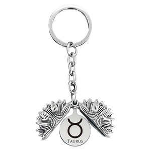 Macro shot of Taurus sunflower keychain with vintage silver finish and engraved zodiac sign