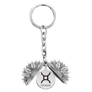 Silver Gemini sunflower locket keychain with zodiac engraving and spinning petals